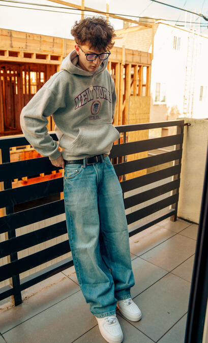 Colin Allen also known as thatiscolin standing on a balcony in Los Angeles capturing lifestyle content