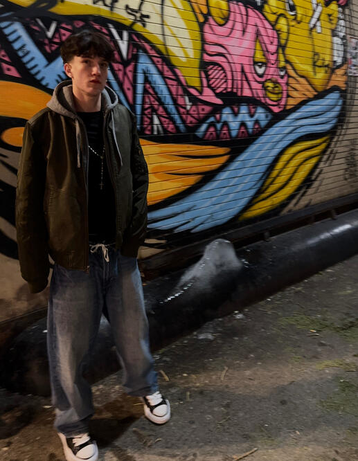 Colin Allen also known as thatiscolin pictured modeling infant of graffiti wall in Chicago.